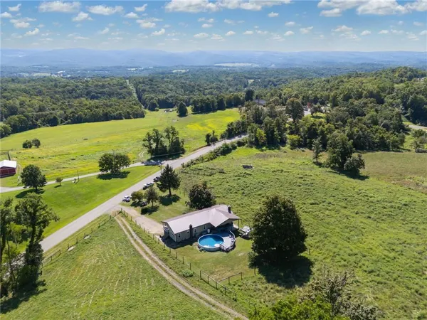an aerial view of a house with a yard