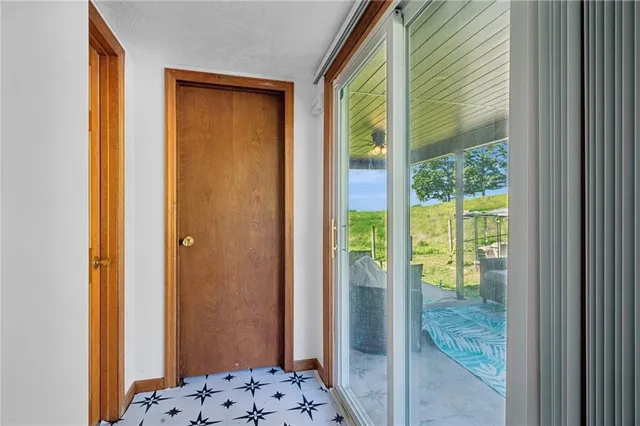 a view of bathroom and hallway