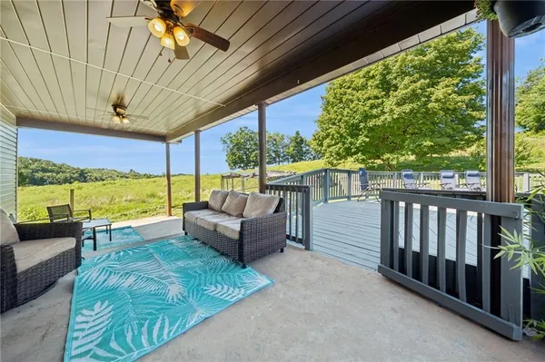 a balcony with furniture and a garden