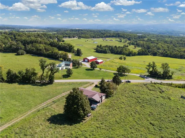an aerial view of a houses with a yard