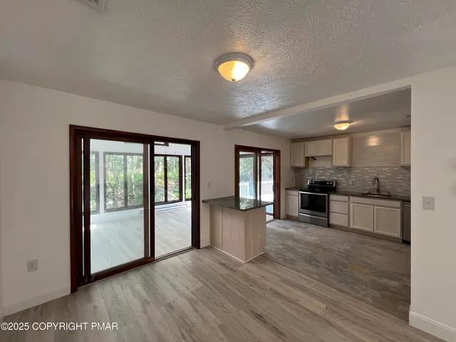 a kitchen with stainless steel appliances granite countertop a refrigerator and stove