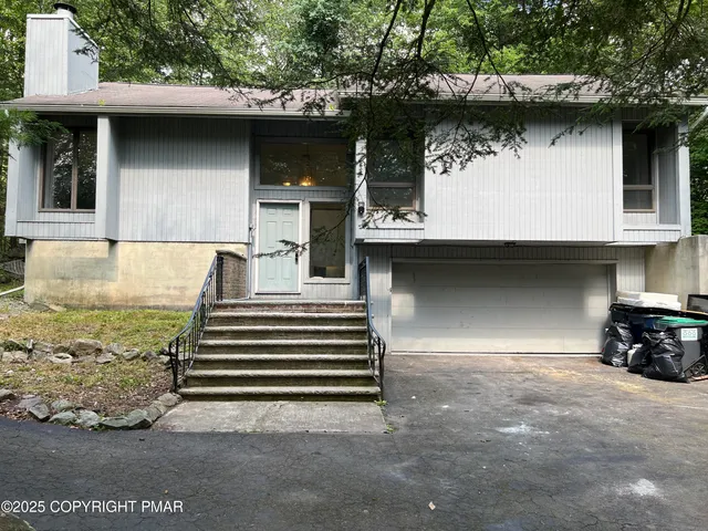 a view of a wooden deck and a yard with some plants