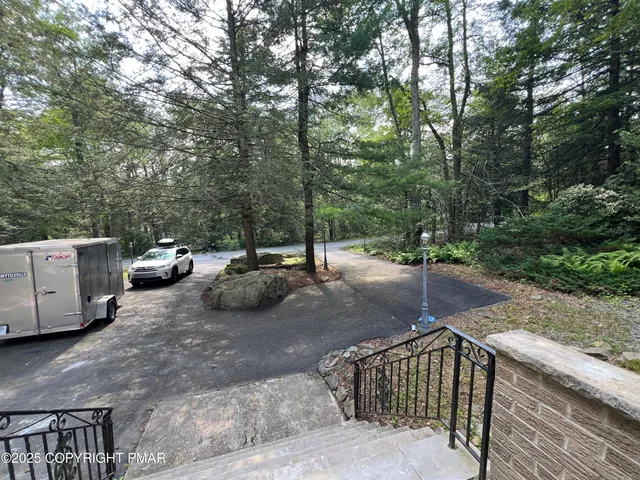a view of a street with cars parked