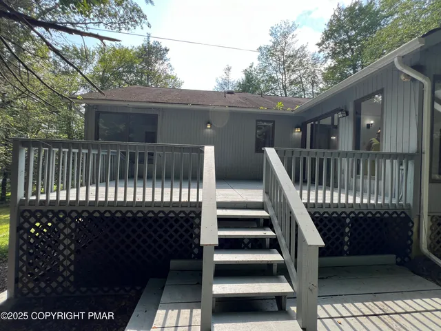 a view of a deck with wooden floor and fence