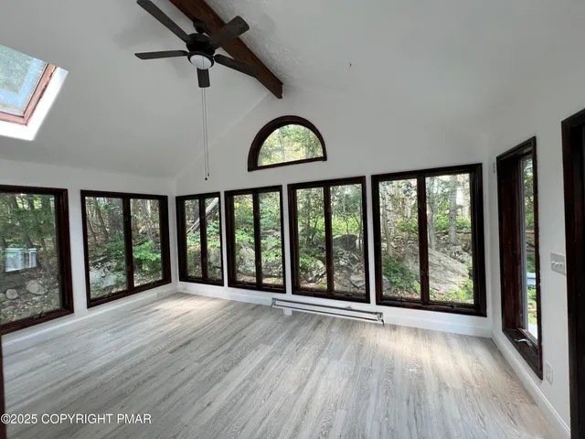 wooden floor in an empty room with a window