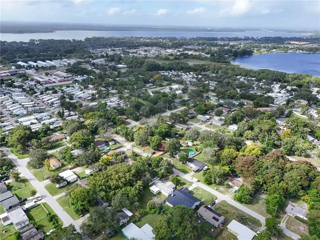 an aerial view of residential houses with city view