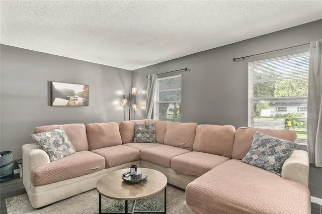 a living room with furniture and a large window