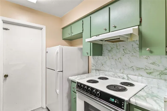 a kitchen with a stove and a refrigerator
