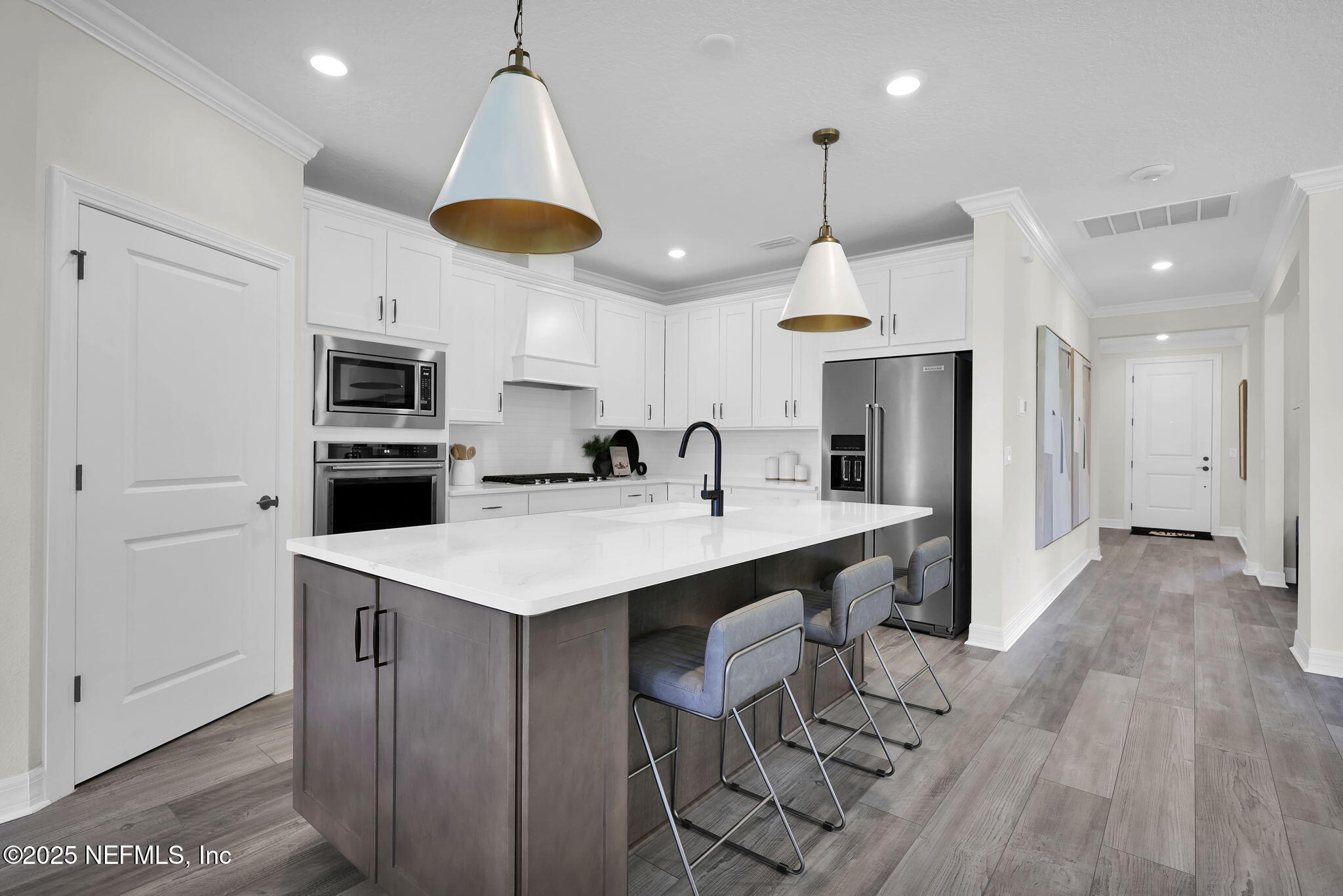 168 Coordinate Lane St. Johns, FL 32259 - Photo 6 of 22 a kitchen with kitchen island a sink stainless steel appliances and cabinets