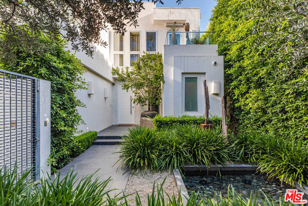 front view of a house with potted plants