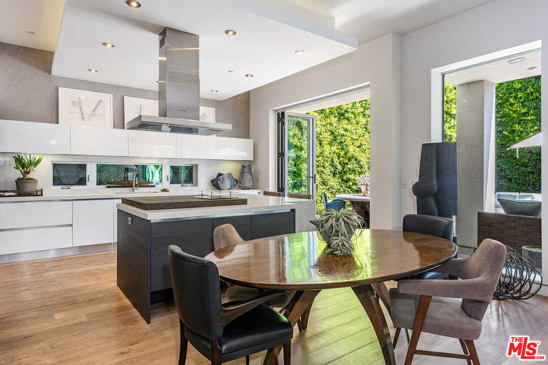 6236 Drexel Avenue Los Angeles, CA 90048 - Photo 15 of 33 a dining room with furniture a window and a kitchen view