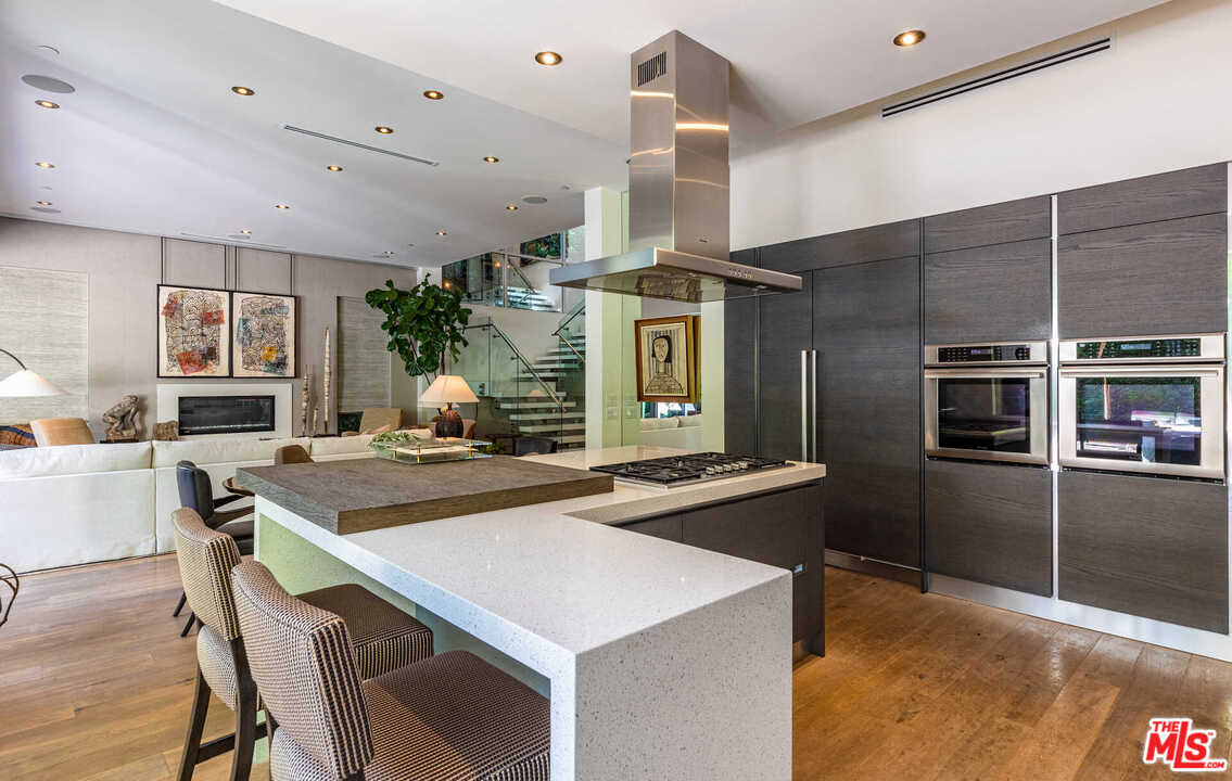 6236 Drexel Avenue Los Angeles, CA 90048 - Photo 17 of 33 a kitchen with stainless steel appliances kitchen island granite countertop a sink and stove