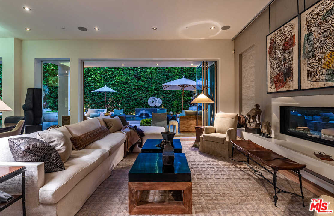 6236 Drexel Avenue Los Angeles, CA 90048 - Photo 4 of 33 a living room with furniture a large window and a fireplace