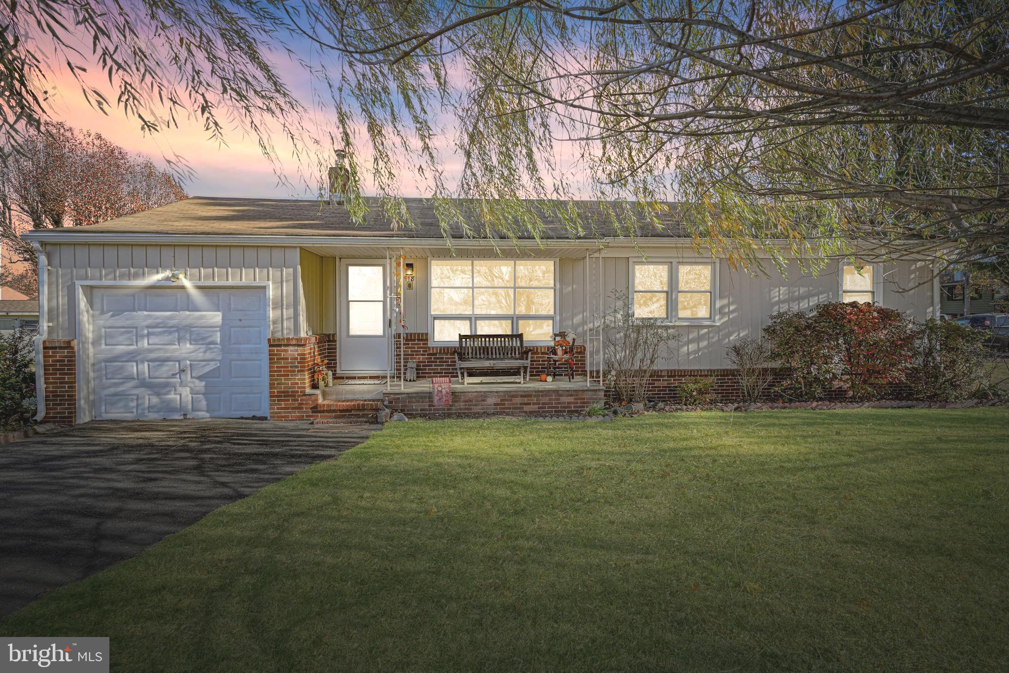 a front view of a house with a yard table and chairs