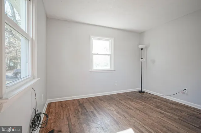 a view of a room with wooden floor
