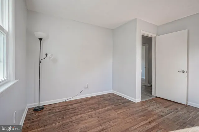 a view of a room with wooden floor and windows