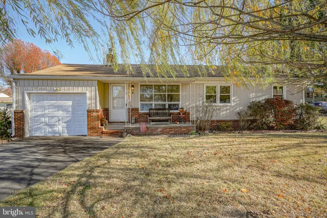 a kitchen with stainless steel appliances white cabinets and wooden floors