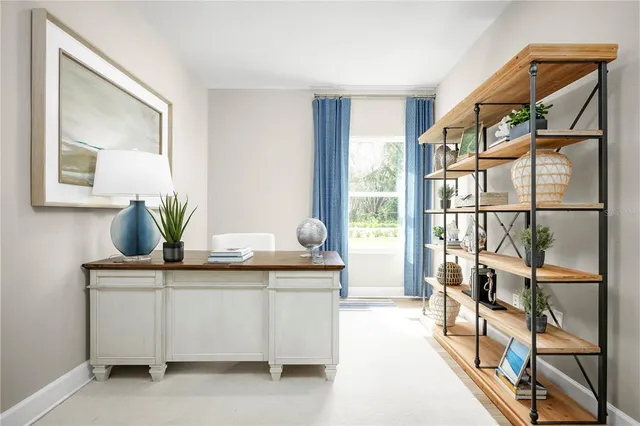 a living room with a balcony a bed and a potted plant
