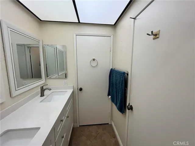 a bathroom with a sink a mirror and a shower
