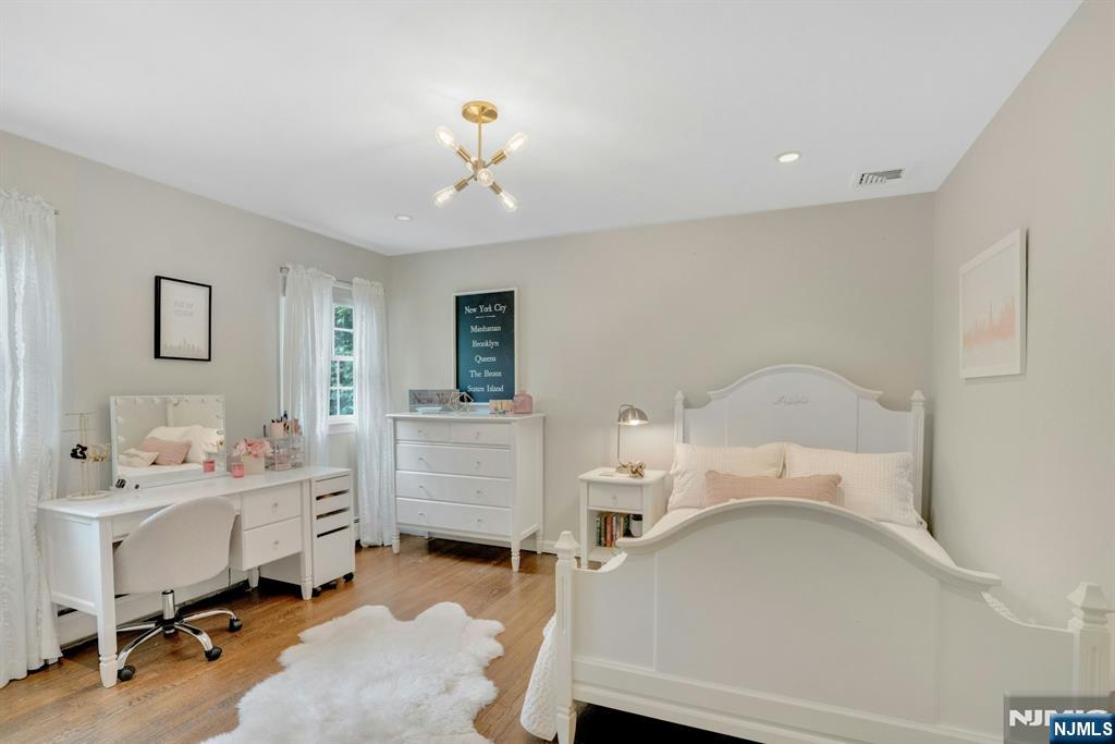48 Hopper Farm Road Upper Saddle River, NJ 07458 - Photo 21 of 43 a room with a baby bed a desk and chair