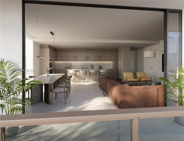 a living room with furniture and potted plants