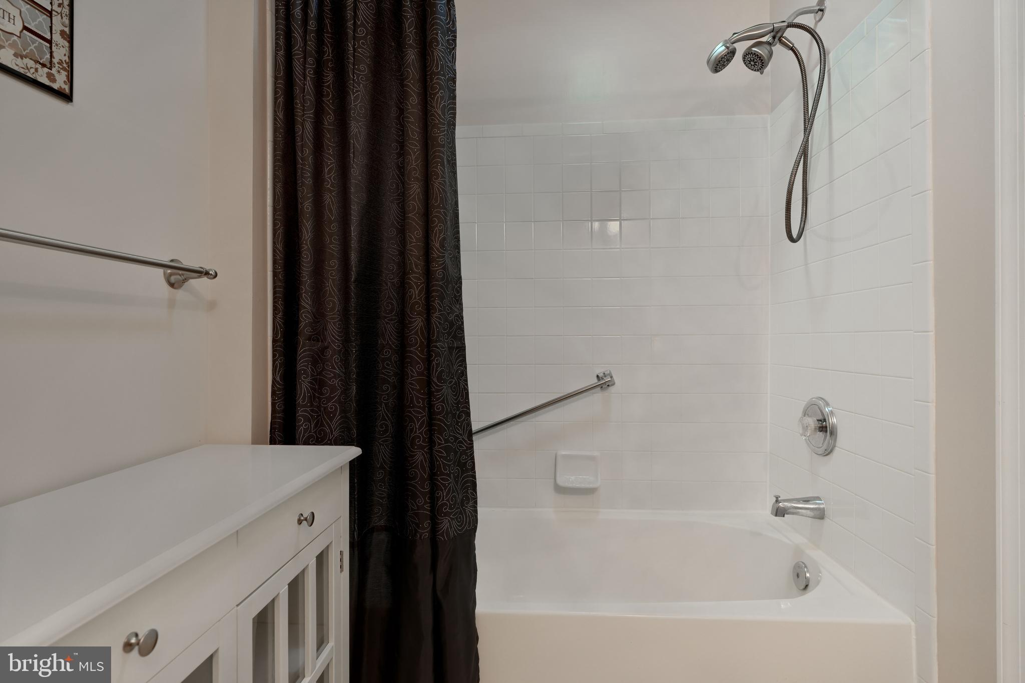 5318 Millfield Road, Unit 5318 Rosedale, MD 21237 - Photo 14 of 26 a bathroom with a shower and a bath tub