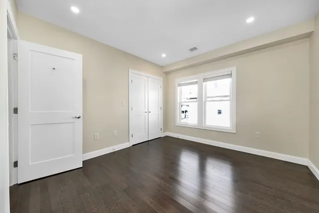 a view of kitchen with refrigerator and windows