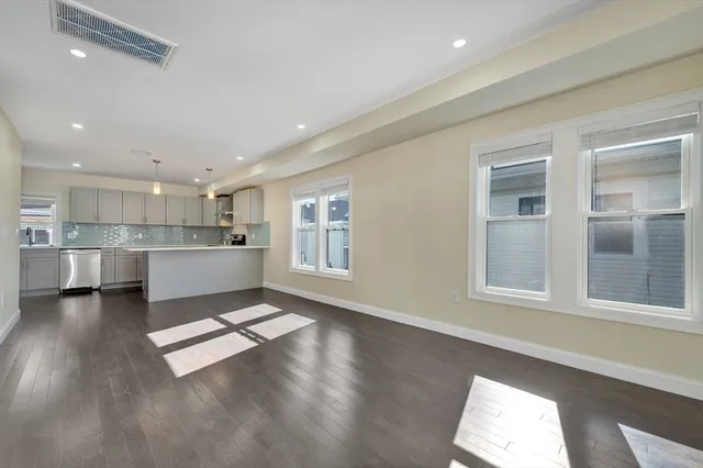 a kitchen with kitchen island granite countertop a sink cabinets and stainless steel appliances