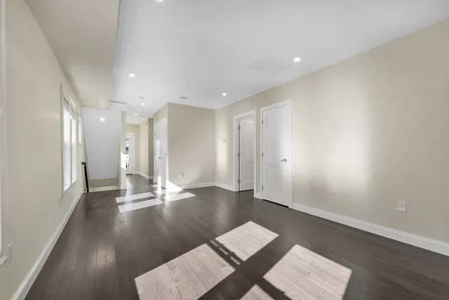 a kitchen with stainless steel appliances a sink cabinets and wooden floor