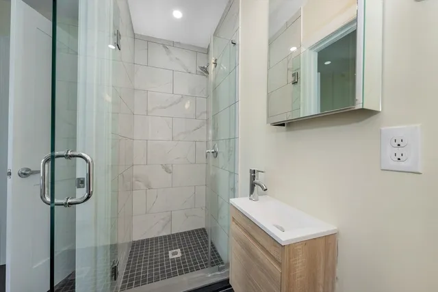 a bathroom with a sink a toilet and shower