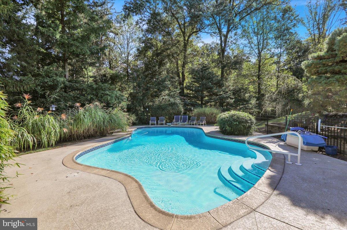 7 Hessian Boulevard Reading, PA 19607 - Photo 57 of 71 Serene poolside retreat amidst lush greenery.
