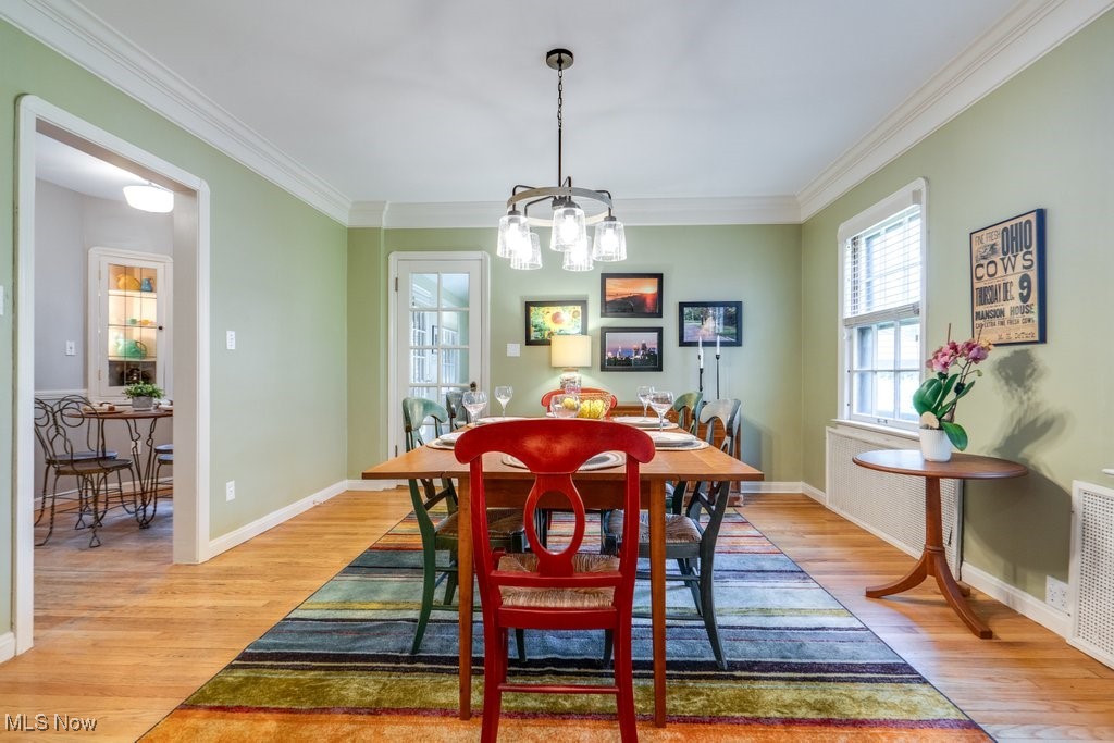 2500 Eaton Road Cleveland, OH 44118 - Photo 21 of 50 Dining space featuring light wood finished floors, a chandelier, ornamental molding, and baseboards