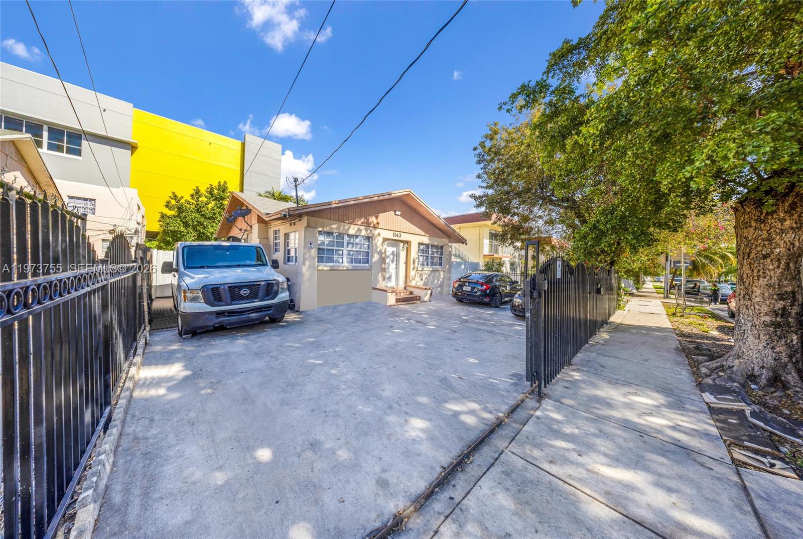 1143 Northwest 6 Street Miami, FL 33136 - Photo 5 of 18 a view of a car park in front of house