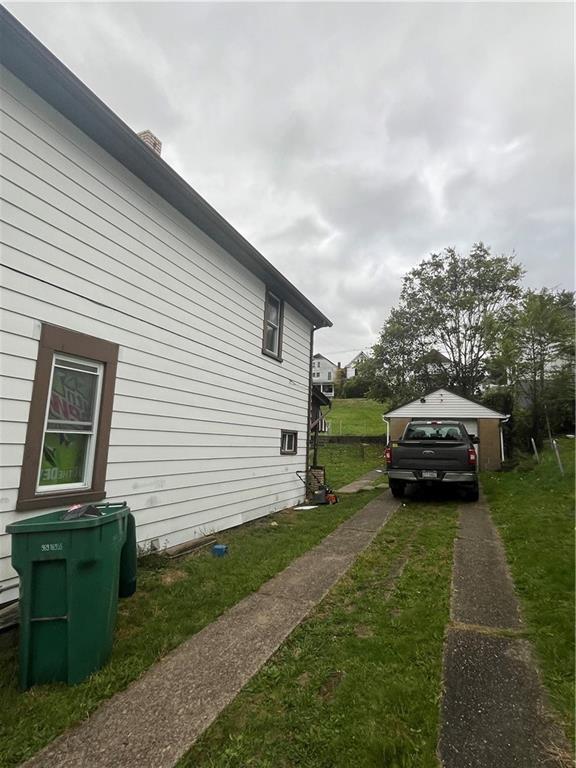 924 Locust Avenue Monessen, PA 15062 - Photo 3 of 25 a view of a yard with a car parked in it