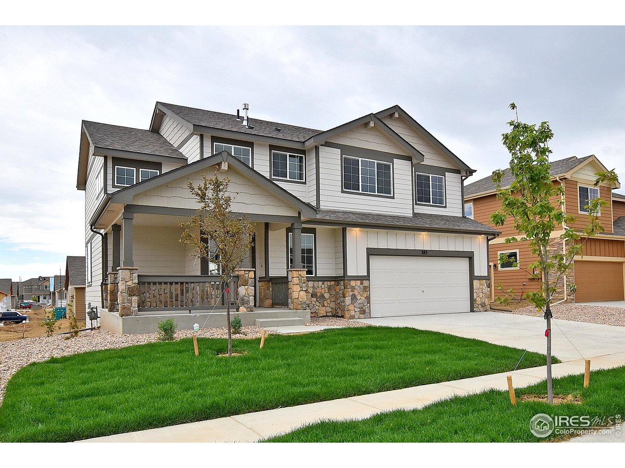 312 August Lane Windsor, CO 80550 - Photo 2 of 40 a front view of a house with a garden and plants