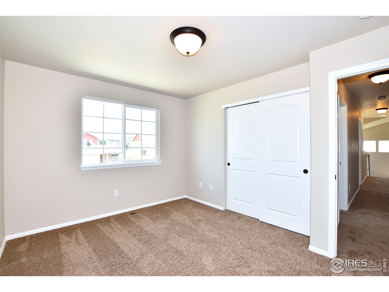 312 August Lane Windsor, CO 80550 - Photo 33 of 40 a view of an empty room with wooden floor