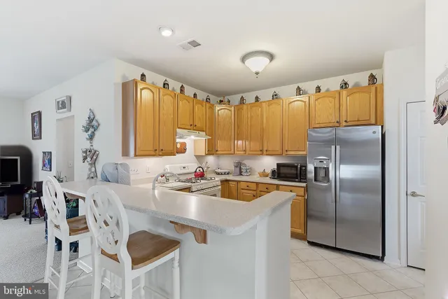 a kitchen with kitchen island a counter top space appliances and a counter space