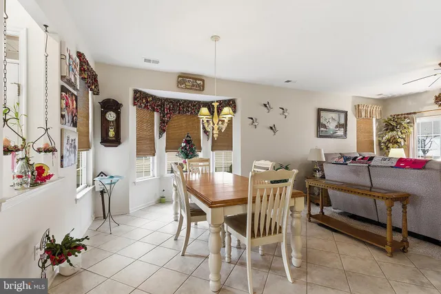 a view of a dining room with furniture and chandelier