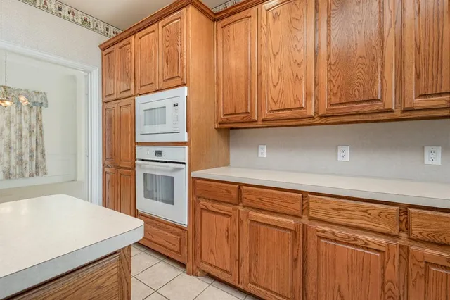 a kitchen with stainless steel appliances granite countertop a refrigerator and cabinets