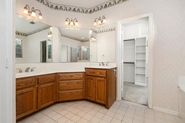 a spacious bathroom with a double vanity sink mirror and