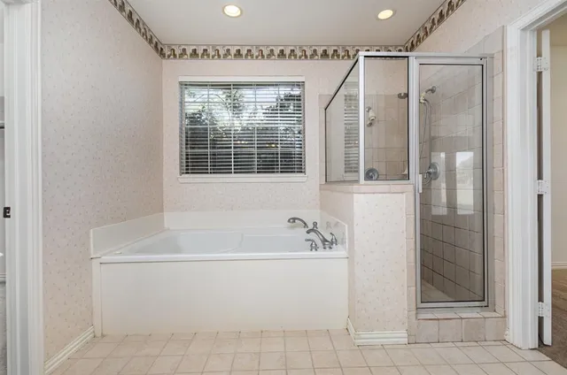 a white bath tub sitting next to a shower