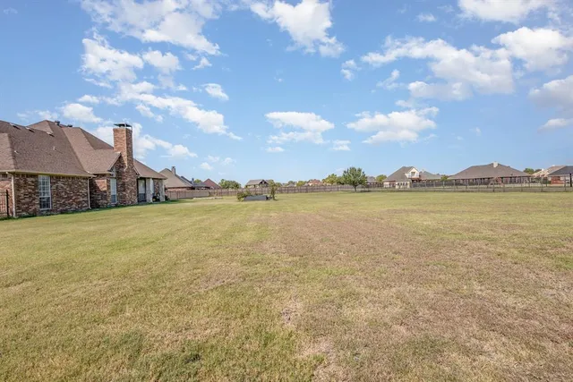a view of a lake with houses in the back