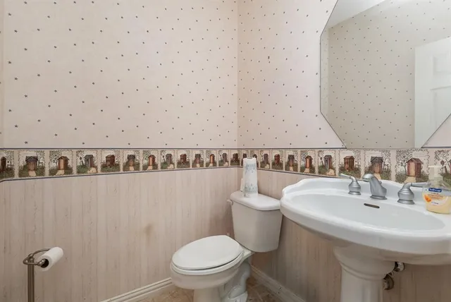 a kitchen with stainless steel appliances granite countertop white cabinets and sink