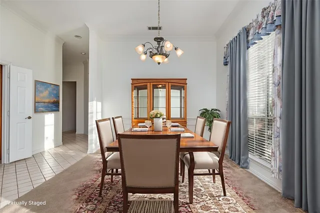 a dining room with furniture a rug and a chandelier