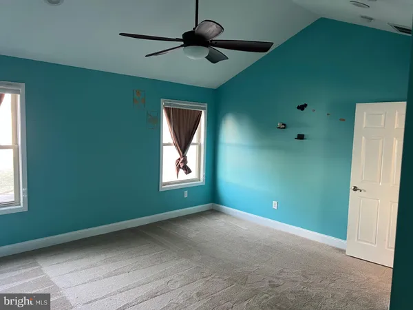 a view of room with window and ceiling fan
