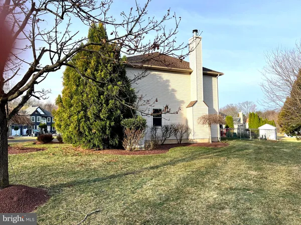 a view of a yard with a house in the background