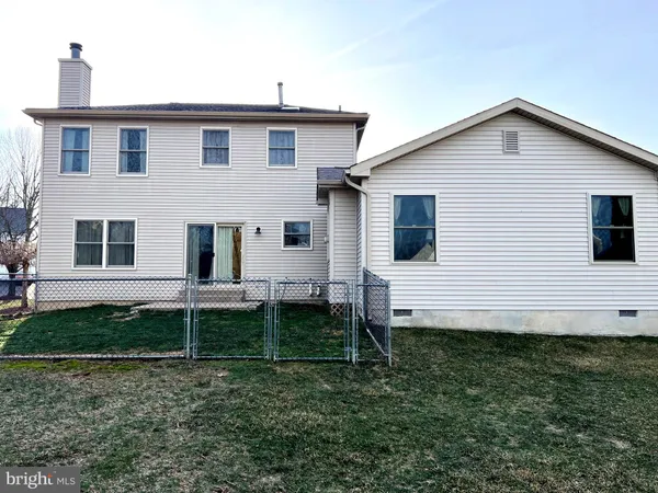 a view of a white house next to a yard