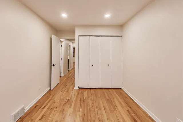 a view of hallway with wooden floor