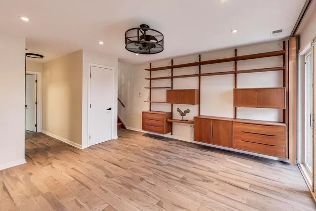 a view of a room with racks and lots of wooden floors