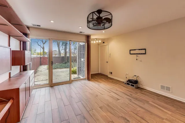 a view of a room with wooden floor and windows